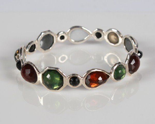 Ippolita Wonderland Mini Hero Bangle: Ippolita Wonderland Mini Hero sterling silver bangle with semiprecious stones. 20th century. Hammered sterling silver bangle set with green quartz, onyx, orange quartz, and maroon quartz doublets back