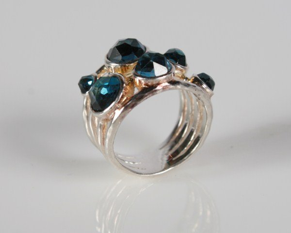 Ippolita Rock Candy Sterling and Blue Topaz Ring: Ippolita Rock Candy ring. 20th century. Hammered sterling silver ring set with three rows of faceted blue topaz. Total weight 8.1 grams.