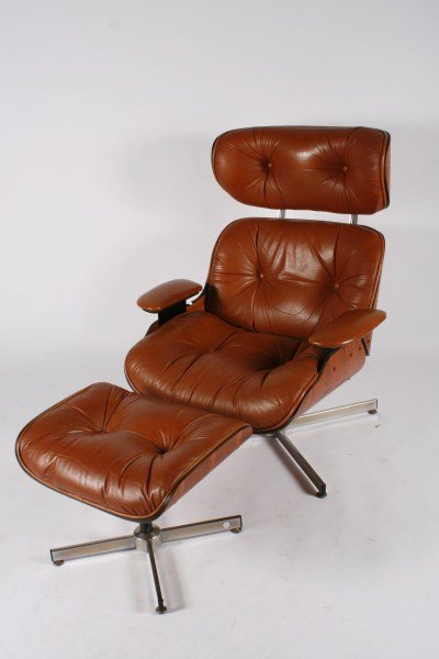 Selig Eames Style Lounge Chair and Ottoman: Selig Eames style lounge chair and ottoman. Molded walnut shells with caramel-colored Naugahyde upholstered cushions raised on an aluminum and chromed metal base. Signed with Height 39", width 32", de