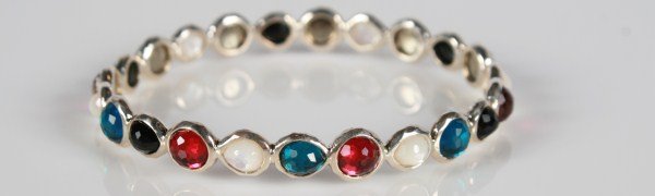 Ippolita Wonderland Bangle: Ippolita Wonderland bangle with semiprecious stones. 20th century. Hammered sterling silver bangle set with rose quartz, mother-of-pearl, aqua quartz and onyx doublets backed with mother-of-pearl. Tot