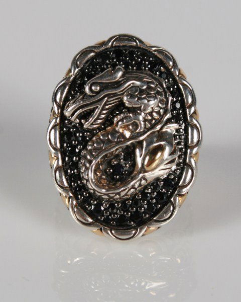 John Hardy Naga Oval Ring: John Hardy Naga sterling silver and 18 karat yellow gold oval ring set with black sapphires. 20th century. Ring size 6. Total weight 17.8 grams.
