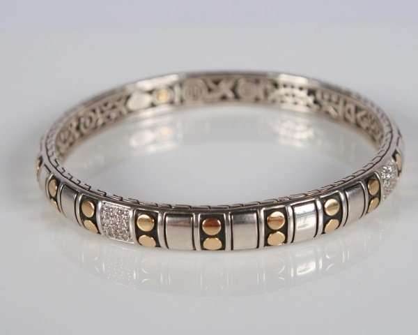 John Hardy Four-Station Dot Bangle: John Hardy Four-Station sterling silver and 18 karat gold dot bangle set with diamond pavé, total weight .52 ct. Total weight 28.3 grams.