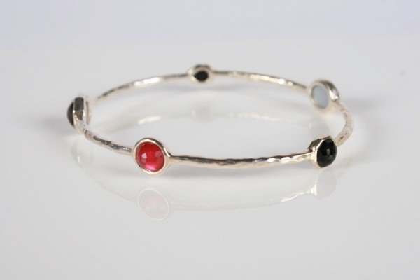 Ippolita Wonderland Bangle: Ippolita Wonderland sterling silver bangle with semiprecious stones. 20th century. Hammered sterling silver bracelet with rose quartz, onyx, and maroon quartz doublets backed with mother-of-pearl. Tot