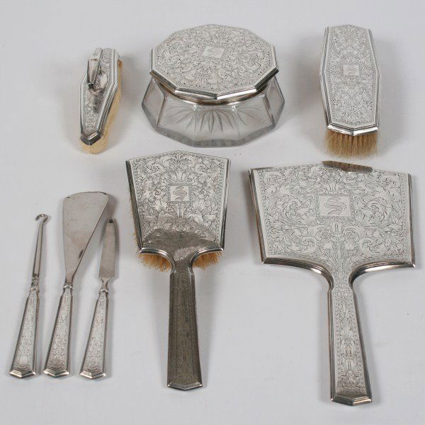 R. Blackington & Co. Sterling Mounted Dresser Set: R. Blackington & Co. sterling silver mounted dresser set. American. Dresser set having eight pieces, including: a hand mirror, a hair brush, a clothes brush, a shoe horn, a nail file, a nail buffer, a