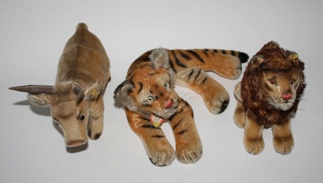 Group of 3 Steiff Stuffed Animals: Group of three Steiff stuffed animals. German, 20th century. Three stuffed animals, including: a "Texas Longhorn" stuffed animal, a lion stuffed animal, and a tiger stuffed animal. All stuffed animals