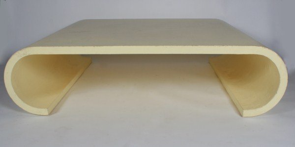 Karl Springer Waterfall Coffee Table: Karl Springer waterfall coffee table. American, 20th century. Coffee table having a cream lacquer over a linen top and scroll form legs. Unmarked. Height 15 1/2", width 60", depth 48".
