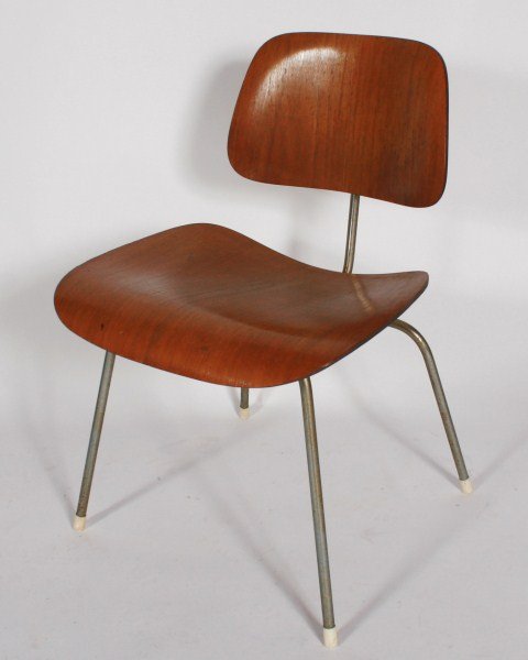 Charles and Ray Eames Molded Plywood Chair: Charles and Ray Eames molded plywood chair. American, circa 1940s. Made by Herman Miller. Chair having a molded plywood seat and back on a polished chrome frame. With manufacturer's foil label to unde
