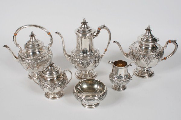 An American Sterling Tea and Coffee Service: An American hand chased sterling silver tea and coffee service. Having six pieces, including: 1 coffee pot, 1 teapot, 1 tea kettle, 1 two-handled covered sugar, 1 creamer, and 1 footed bowl. Coffee po