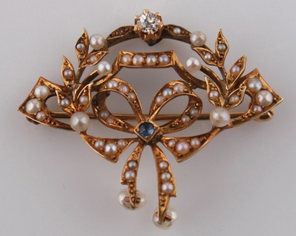 Ladies 14K Seed Pearl, Sapphire, and Diamond Pin: Ladies 14K pin set with 45 seed pearls, 1 round blue sapphire, total weight .03 ct., and 1 round diamond, total weight.12 ct., clarity I3, color I. Total weights 5.0 grams.