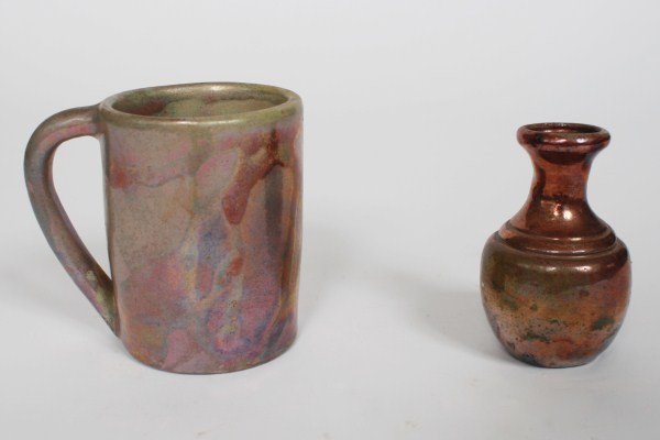 Pewabic Iridescent Pottery Mug and Miniature Vase: Pewabic iridescent pottery mug and miniature vase. Both pieces unmarked. Height of mug 4", height of miniature vase 3 5/8".Provenance: From the personal collection of Bonnie Ault, formerly married to 