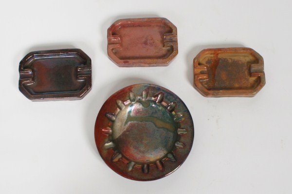 Group of 4 Pewabic Pottery Ashtrays: Group of four Pewabic pottery ashtrays. American, 20th century. Four pottery ashtrays having iridescent glazes. All pieces with "Pewabic Detroit" impressed marks to base. Height 3/4", width of longest