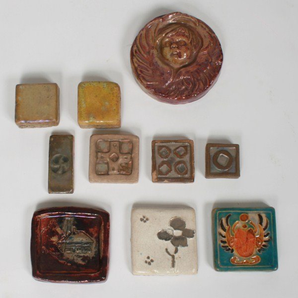 Assorted Group of Ten Pewabic Pottery Articles: Assorted group of ten Pewabic pottery articles. American, 20th century. Assorted group of ten articles includes: a tile depicting the Scarab Club emblem (marked); an iridescent tile depicting the Pewa