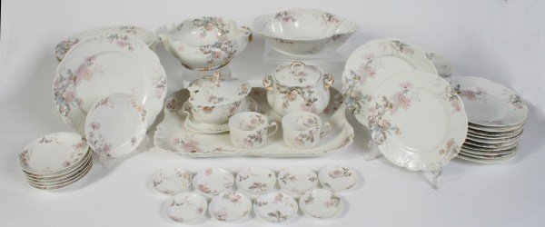Haviland & Co. Limoges Porcelain Dinner Service: Haviland & Co. Limoges porcelain dinner service. Decorated with floral motif on white ground with gilt accents. With 57 pieces, including: 12 dinner plates; 11 salad plates; 11 dessert plates; 7 sauce