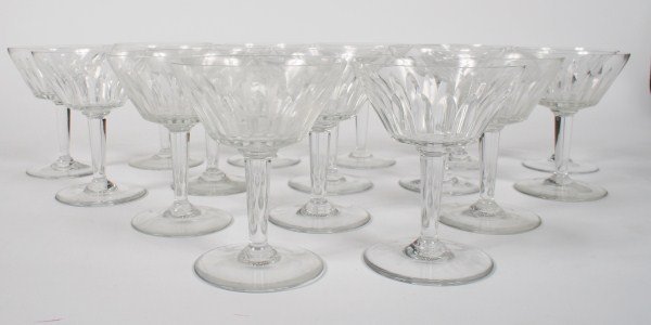 16-Piece Set of Baccarat Champagne Coupes: 16-piece set of Baccarat crystal champagne coupes. French, 20th century. All glasses with acid etched Baccarat France circular mark to base. Height 5 1/8".