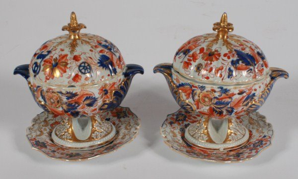 Pair of Mason Ironstone Tureens: Pair of Mason Ironstone tureens. Both having openwork bases, fired gold finials, and matching trays. Height 8 1/2", diameter 7". Provenance: From the Estate of Stephen Stackpole.