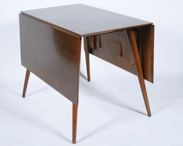 Paul McCobb for Planner Group Drop-Leaf Table: Paul McCobb drop-leaf dining table for Planner Group. American, 20th century. Made by Winchendon Furniture Company. Dining table having a rectangular top with two leaves and raised on tapered legs. Wi