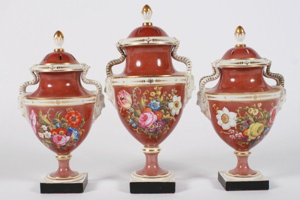 Three-Piece Spode Porcelain Mantle Set: Three-piece Spode porcelain mantle set. Circa 1840. Covered urns having ram's head mounts and floral designs. Height of largest 12". Provenance: From the Estate of Stephen Stackpole.