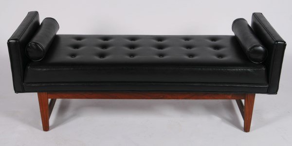 Selig Manufacturing Co. Sofa Bench: Selig Manufacturing Co. sofa bench. 20th century. Sofa bench having tufted black upholstery and a walnut frame. With two associated cylindrical pillows. Having "Selig Manufacturing Co." label to under