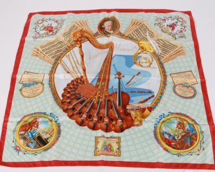 Hermès "Hommage à Mozart" Silk Scarf: Hermès "Hommage à Mozart" silk scarf. French, 20th century. Designed by Julia Abadie. Depicting portrait of Wolfgang Amadeus Mozart, along with various musical instruments. With original Hermès box