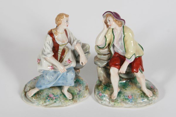 Pair of Capodimonte Porcelain Figurines: Pair of Capodimonte porcelain figurines depicting a man and a woman. Both marked "Made in Italy" and with Capodimonte underglaze marks to undersides. Height 5".