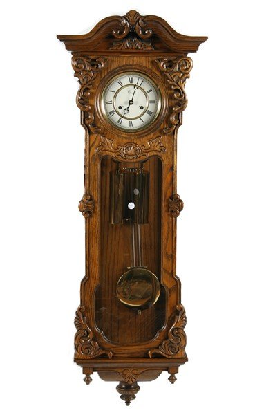 Colonial Zeeland Regulator Wall Clock, c. 1977: Reproduction regulator wall clock by manufacturer "Colonial" from Zeeland, Michigan. Possible oak wood case with ornate carving and decorated pediment. American, c. 1977. Height 47", Width 17", Depth