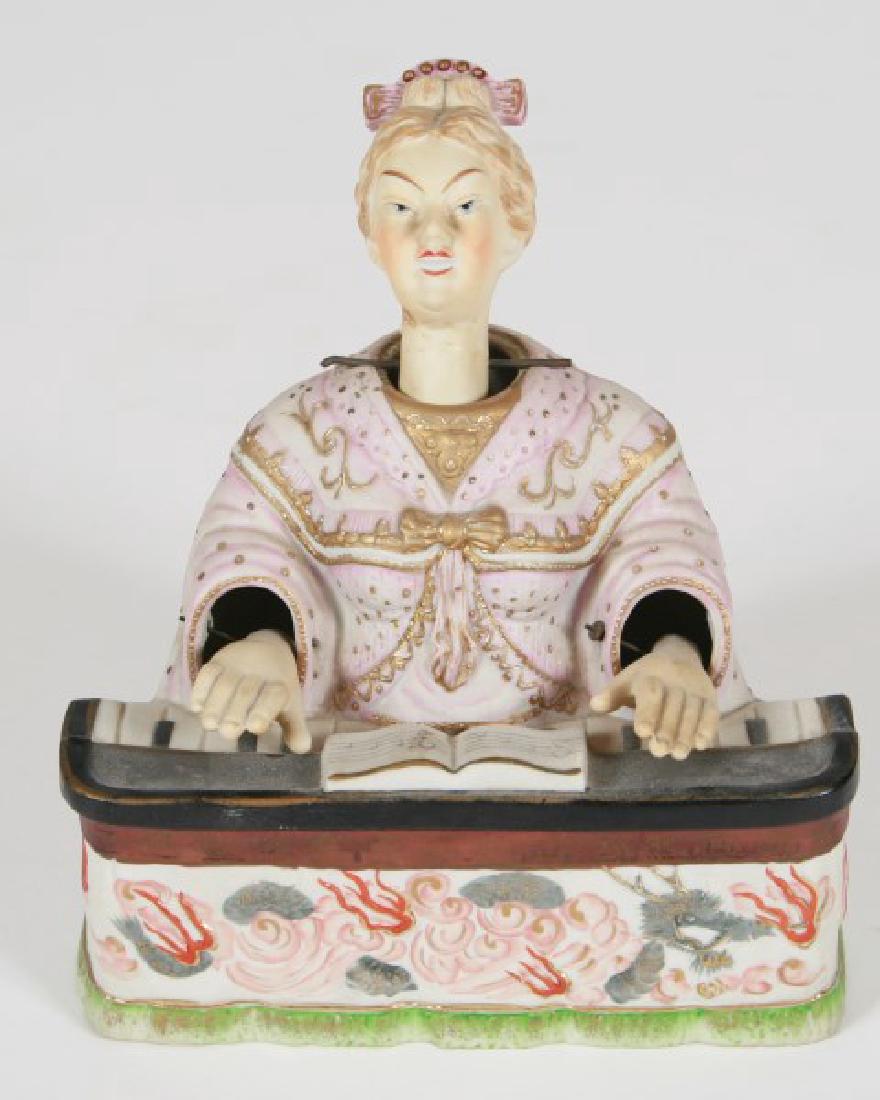 Ardalt Bisque Nodder Figurine: Ardalt bisque nodder figurine. Japanese, 20th century. Height 8 1/2", length 7 1/2", width 5 1/2". Bisque nodder figurine depicting a woman sitting at a piano. Head attachment and hand attachments mov