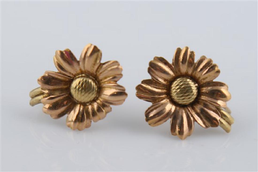 Pair of 14k Rose & Yellow Gold Daisy Earrings: 14k rose and yellow gold screw back earrings with a daisy motif. Weighing 4.6g.