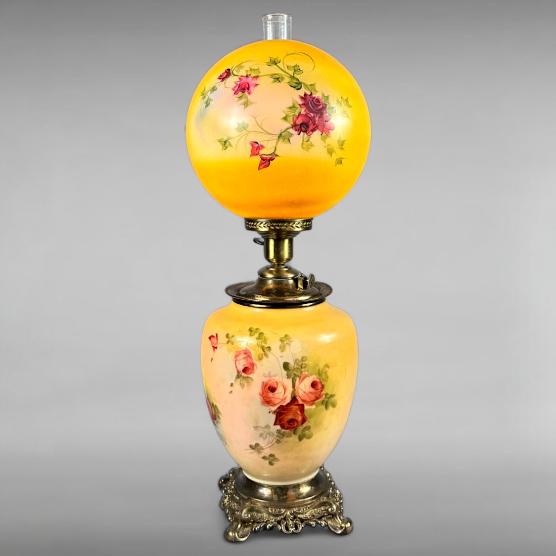 Antique Victorian Hand-Painted Floral Glass Parlor Lamp: Antique Victorian Hand-Painted Floral Glass Parlor Lamp – Converted Oil Lamp Striking Yellow Glass • Rose Motifs • Ornate Brass Base This vibrant antique parlor lamp features a striking ye