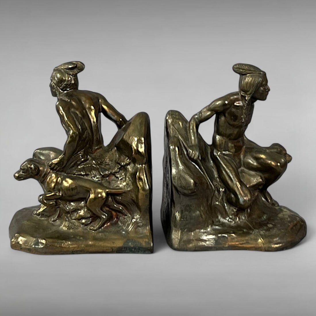 1930s Bronze Finished Cast Metal Bookends in the Style of Jennings Brothers: 1930s Bronze Finished Cast Metal Bookends — Native American Hunters with Dogs, in the Style of Jennings Brothers Machine Age Sculpture • Western Hunting Scene • Bronze Patina Cast Metal Th