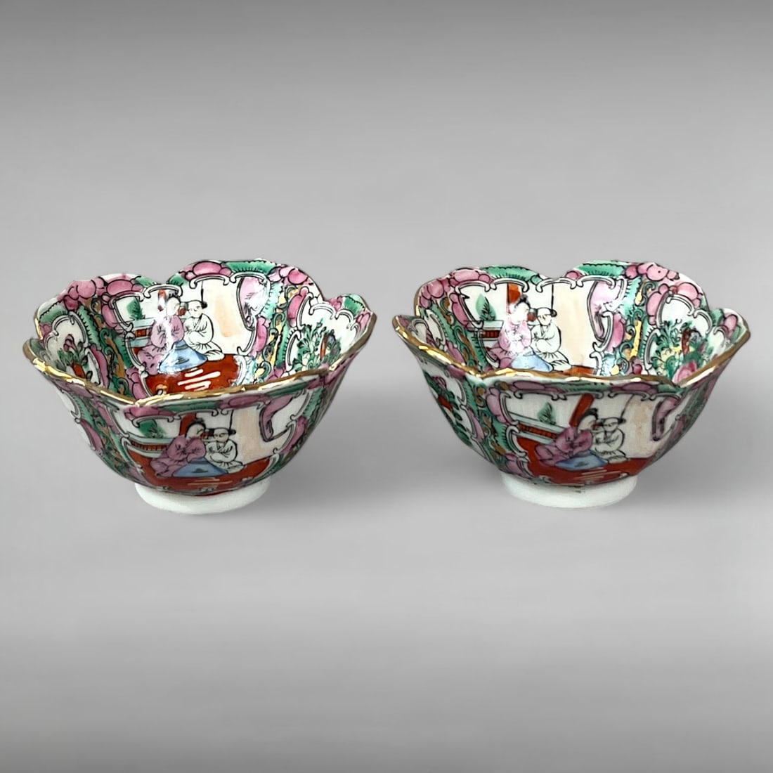 Pair of Chinese Porcelain Rice Bowls — Famille Rose with Qianlong Mark: Pair of Chinese Porcelain Rice Bowls — Famille Rose with Qianlong Mark Flower-Shaped Rims • Figural & Floral Panels • Gilt Edges & Qing Homage This pair of Chinese porcelain rice bowls fea