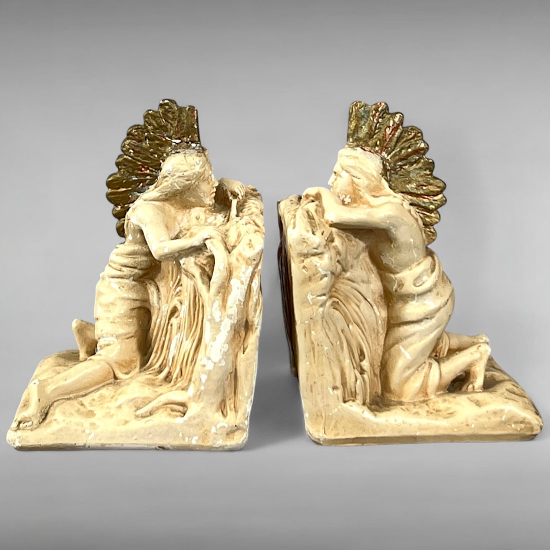 1920s–1930s Plaster Bookends Native American Warriors in Hiding, Folk Art Decorative Pair: 1920s–1930s Plaster Bookends Native American Warriors in Hiding, Folk Art Decorative Pair Description: This vintage pair of plaster bookends features kneeling Native American warriors in hiding pose