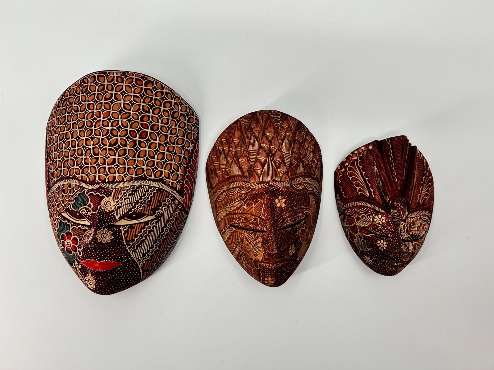 Hand Carved and Painted Batik Masks: Hand Carved and Painted Batik Masks Qty:3 Made in Indonesia 11”x9” 9”x6.5” 7”x6”