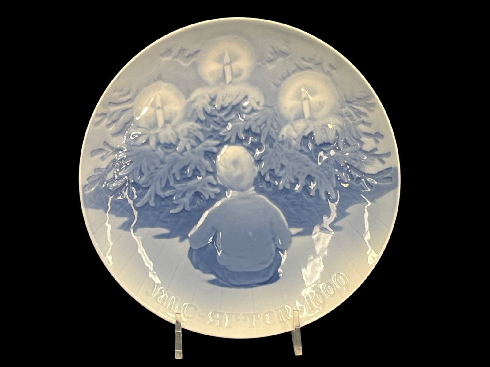 Bing & Grondahl, 1909 Christmas Plate, Happiness Over The Yule Tree: Bing & Grondahl, 1909 Christmas Plate, Happiness Over The Yule Tree Designer: Aarestrup Year: 1909 Porcelain Plate, Blue and White Makers Markings on Bottom 7 1/8” dia. (stand not included)