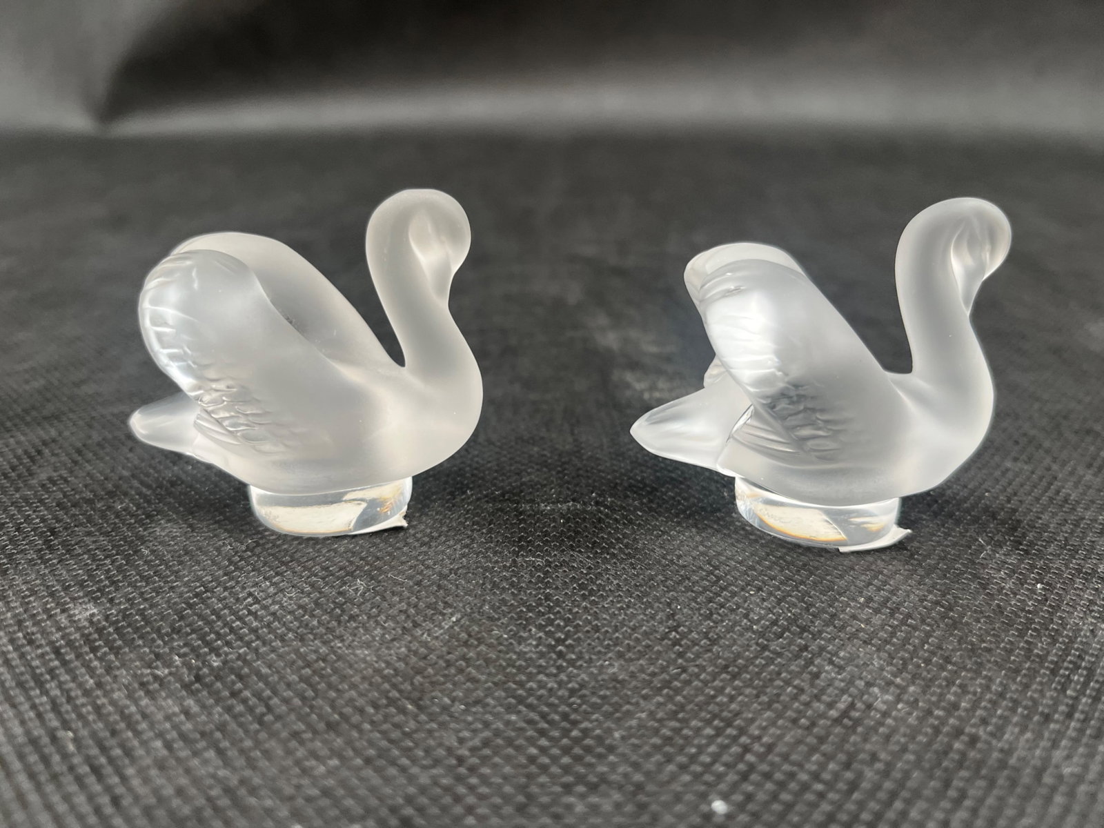 Two Lalique Cygne Swan Seals: Two Lalique “Cygne” Swan Seals # 10603 Etched signatures Dimensions: 2”H x 2.25”W With Original Boxes