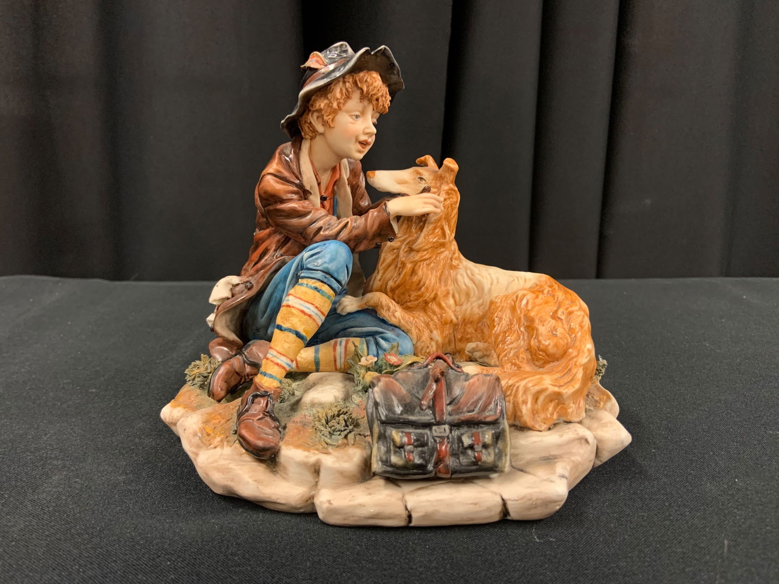 Porcelain Of Capodimonte. Boy & The Dog Lassye: Porcelain Of Capodimonte. Boy & The Dog Lassye. Small hairline crack on dog (see picture) displays well. Handmade in Italy Markers Mark & Stamped (see pictures) H: 6.5”