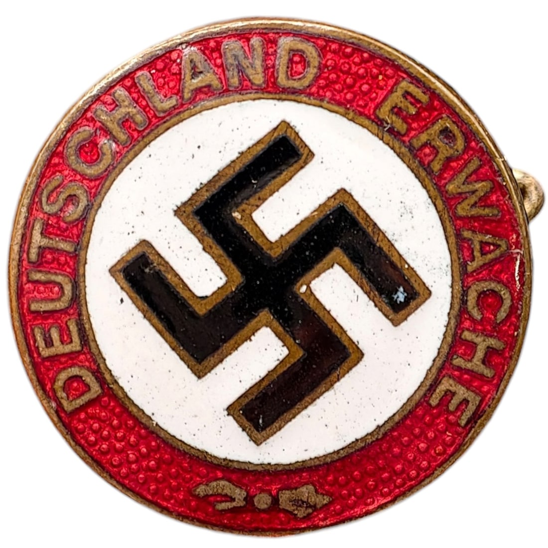 NSDAP Early Slogan Badge Nun Erst Recht: A round pin-back badge with red enamel border reading 'DEUTSCHLAND ERWACHE' (Germany Awaken), surrounding a central white enameled field with a black swastika. Reverse is marked 'GES. GESCH.' (Gesetzl