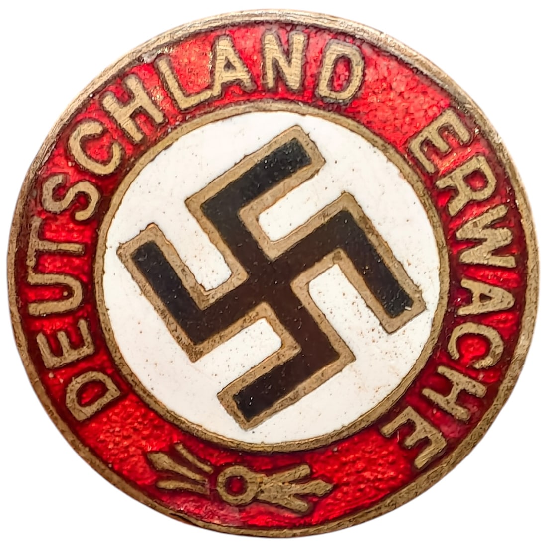 Deutschland Erwache NSDAP Slogan Badge: A round enamel membership/slogan badge with 'DEUTSCHLAND ERWACHE' lettering in gilt on a red enameled ground, encircling a central white enamel field with a black mobile swastika. The reverse is