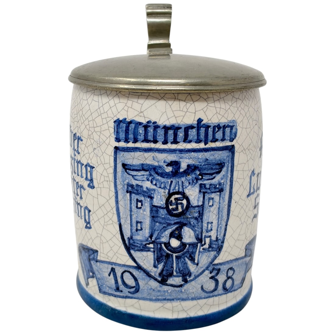 German 1938 Munich Commemorative Stein - Ober/Unter Menzing: A blue and white glazed stoneware stein with a lid believed to be pewter, dated 1938. The body bears the Munich city crest with eagle and crossed towers, flanked by inscriptions reading 'MÜNCHEN' and