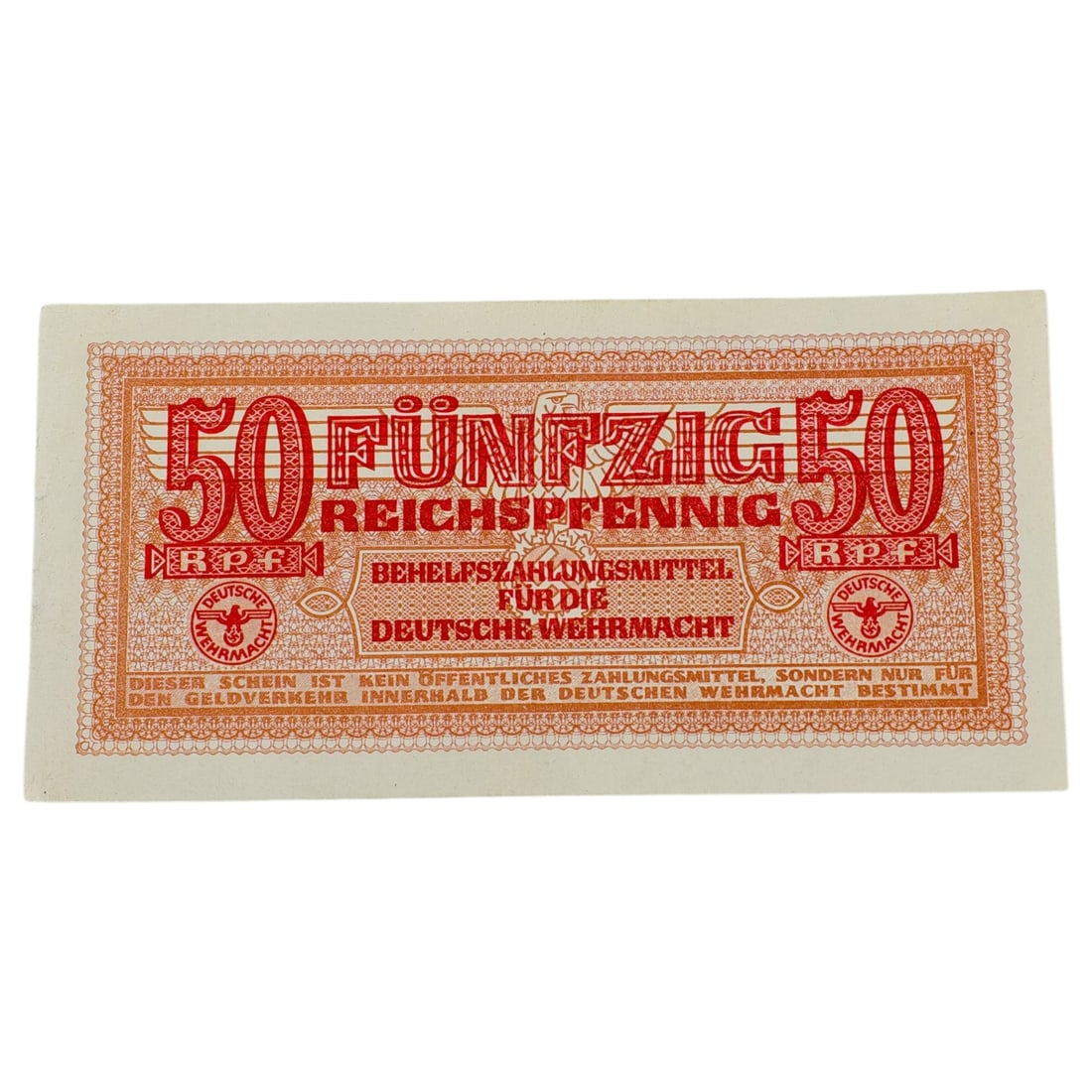 German WWII Wehrmacht 50 Reichspfennig Military Currency Note: A German WWII 'Behelfszahlungsmittel für die Deutsche Wehrmacht' 50 Reichspfennig military scrip note, printed in red/orange with Wehrmacht eagle emblems.