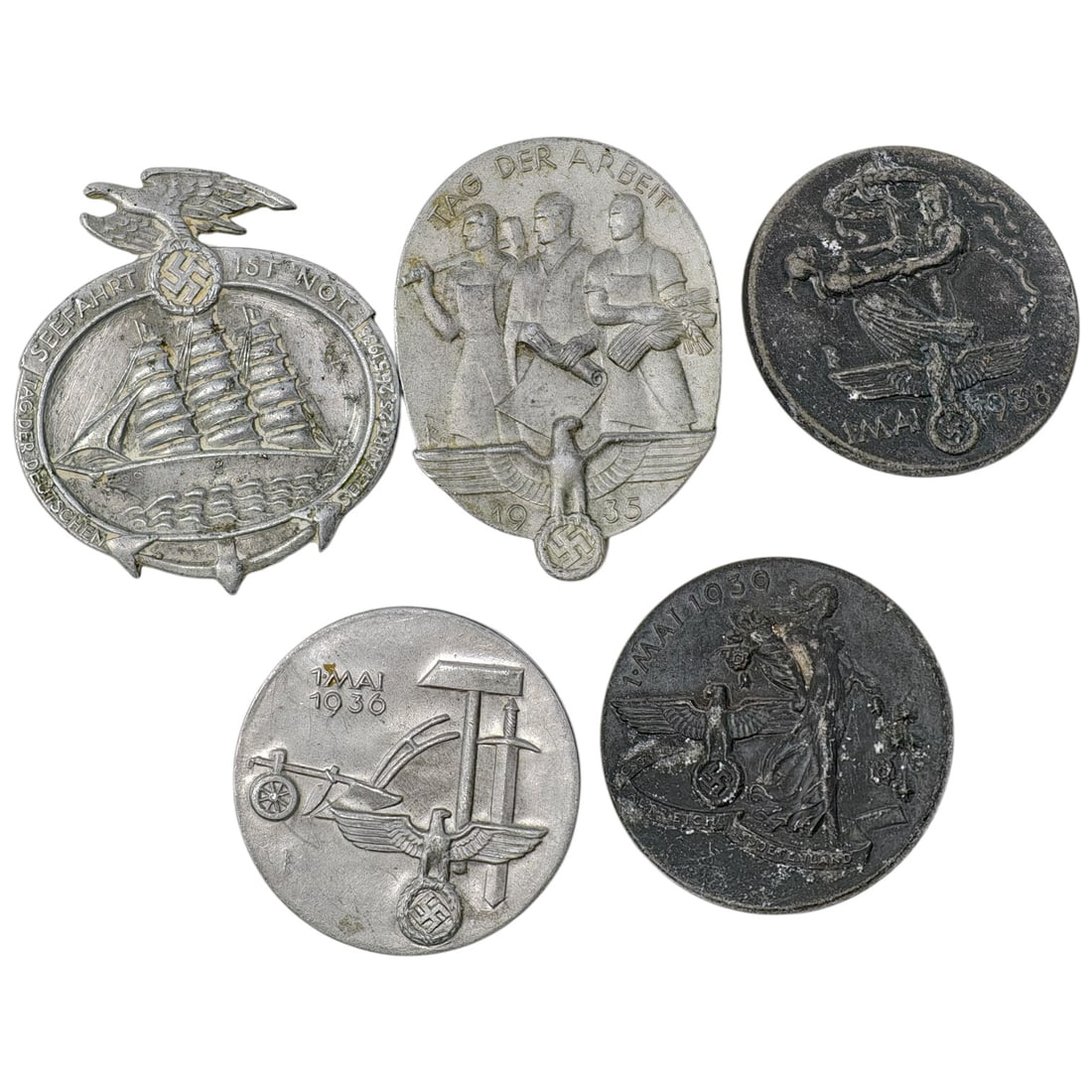 Third Reich Nazi Set of Tinnie Badges: A set of commemorative tinnie badges from the 1930s, worn for events such as Tag der Arbeit (May Day) and maritime/agricultural themed rallies. Markings include "TAG DER ARBEIT 1935", "1 MAI 1936",