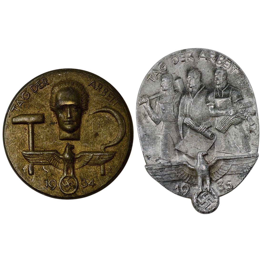 Third Reich Tinnie Set: A pair of pin-back tinnies commemorating the National Labor Day (Tag der Arbeit) celebrations, dated 1934 and 1935. The 1934 example is a round badge in what appears to be brass/bronze-toned metal