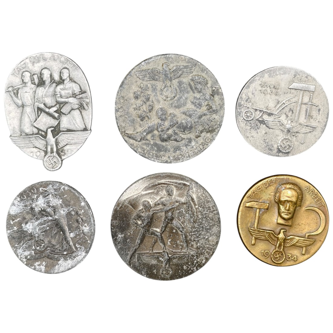 Nazi Third Reich Tinnie Event Badges: A set of commemorative tinnies issued for National Labor Day and related rallies, dated 1930, 1934, and 1936. Designs include stylized workers with tools, an eagle over a crowd, a farm worker with a