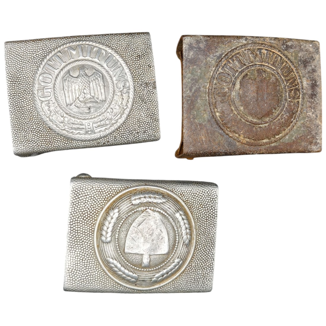 Set of German WWII Enlisted Belt Buckles (Heer & RAD): A set of pebbled-finish belt buckles: Wehrmacht Heer buckles with eagle-and-swastika device within a wreath (one in what appears to be an aluminum/zinc alloy with silvered finish, the other in what ap