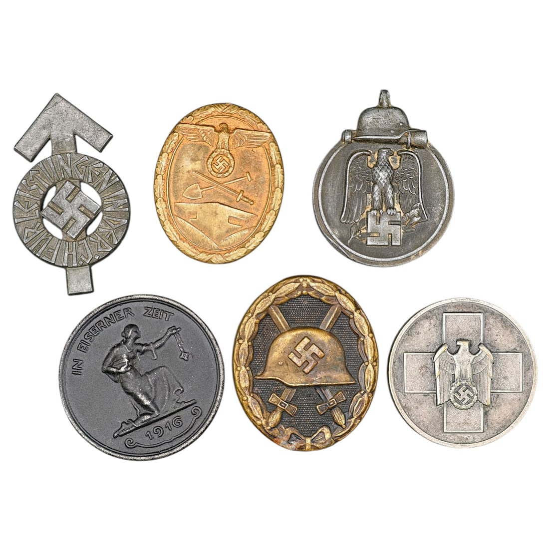 Third Reich Era Set German Badges and Medallions: A mixed lot of German badges and medallions including a Wound Badge in what appears to be gold-grade (marked reverse with maker's oval), a Winterschlacht im Osten 1941/42 (Eastern Front Winter Campaig