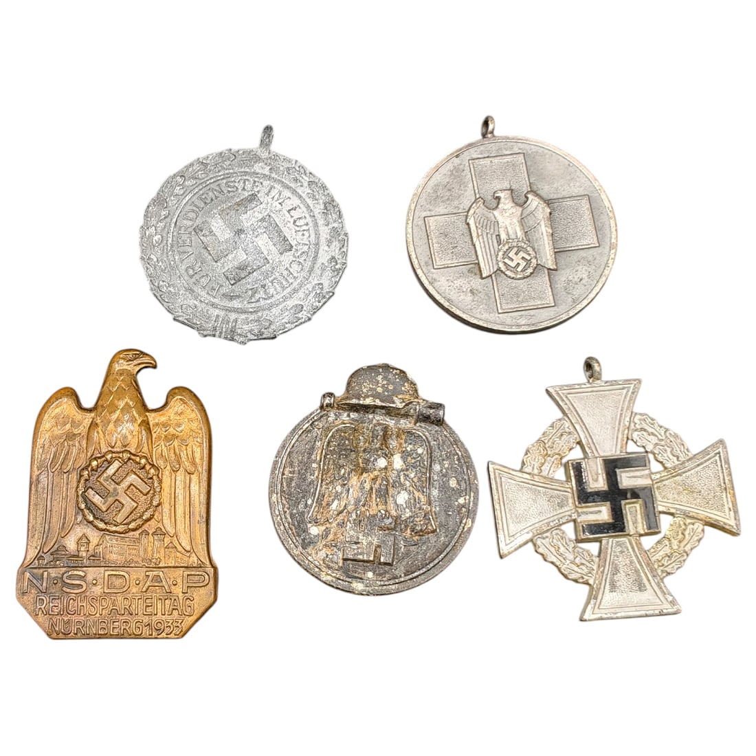 German WWII-Style Medal and Badge Group: Luftschutz Merit Medal, Red Cross/Social Welfare Medal,: A grouping of a set of Third Reich period style badges and medals: a 'Für Verdienste im Luftschutz' (Air Raid Protection Merit) medal, a Social Welfare/Red Cross type medal with eagle and cross, an N