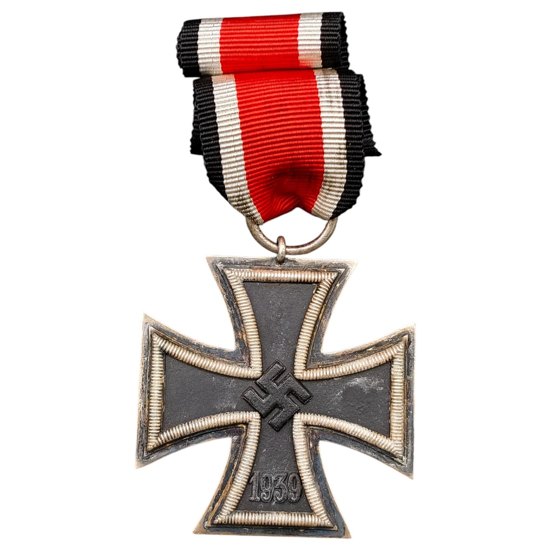 1939 Iron Cross 2nd Class: A World War II German Iron Cross Second Class (Eisernes Kreuz 2. Klasse), dated 1939, obverse featuring a mobile swastika at center and dated 1813 to reverse.