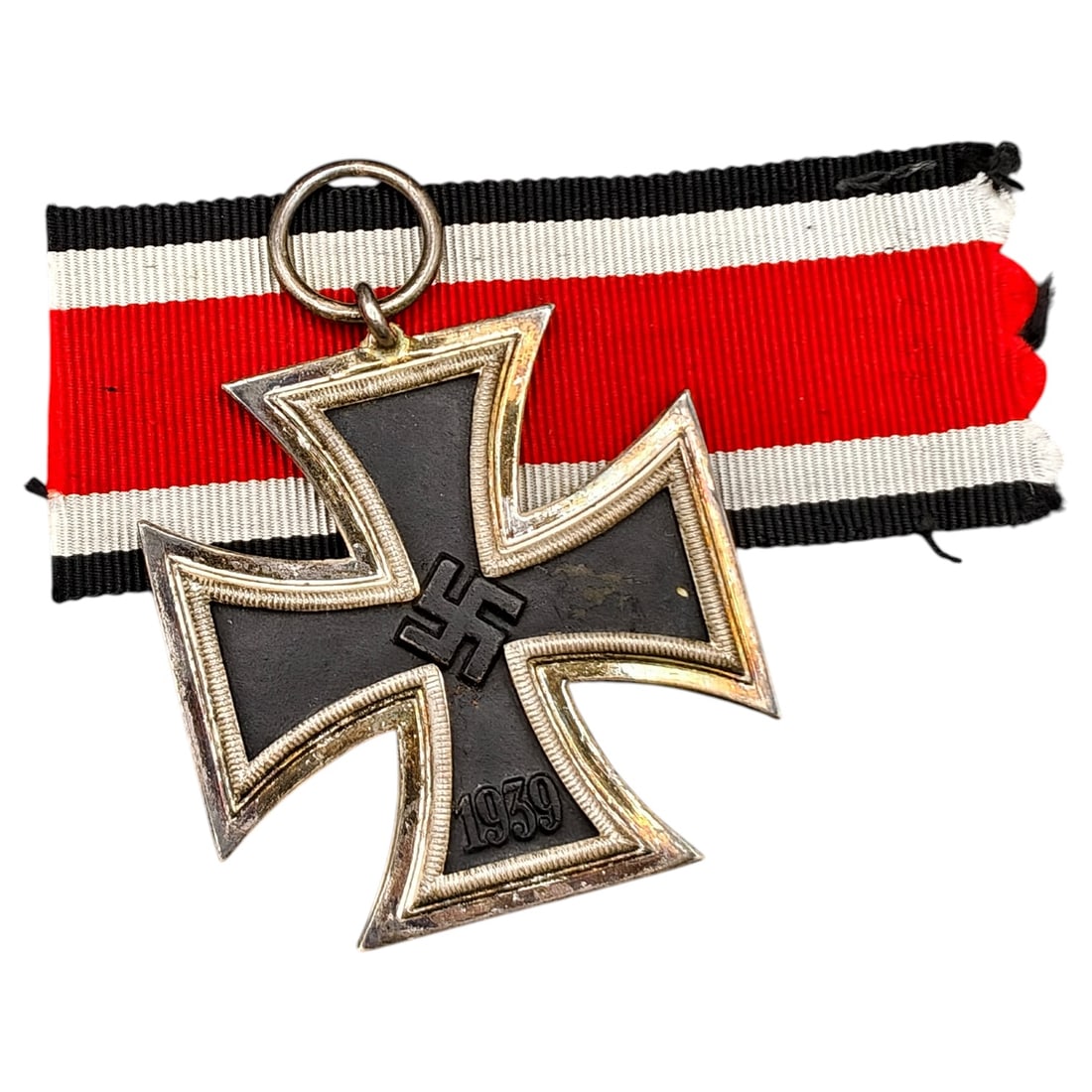1939 Iron Cross 2nd Class: A World War II German Iron Cross Second Class (Eisernes Kreuz 2. Klasse), dated 1939, obverse featuring a mobile swastika at center and dated 1813 to reverse.