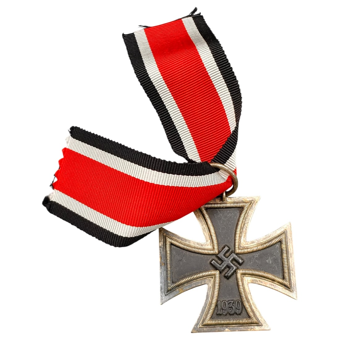 1939 Iron Cross 2nd Class: A World War II German Iron Cross Second Class (Eisernes Kreuz 2. Klasse), dated 1939, obverse featuring a mobile swastika at center and dated 1813 to reverse.