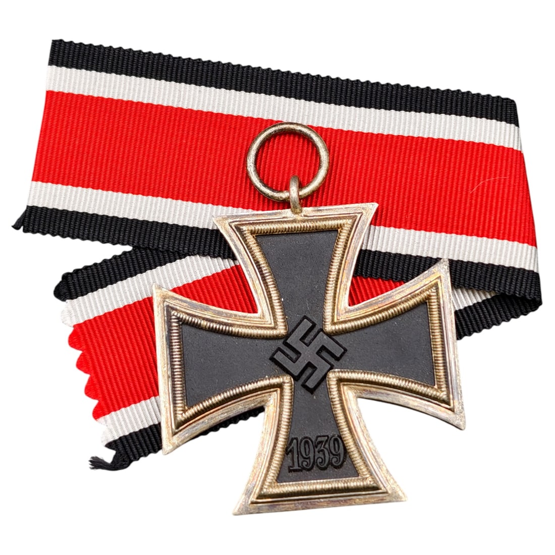 1939 Iron Cross 2nd Class: A World War II German Iron Cross Second Class (Eisernes Kreuz 2. Klasse), dated 1939, obverse featuring a mobile swastika at center and dated 1813 to reverse.