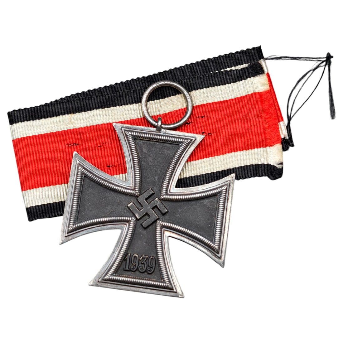 1939 Iron Cross 2nd Class: A World War II German Iron Cross Second Class (Eisernes Kreuz 2. Klasse), dated 1939, obverse featuring a mobile swastika at center and dated 1813 to reverse.